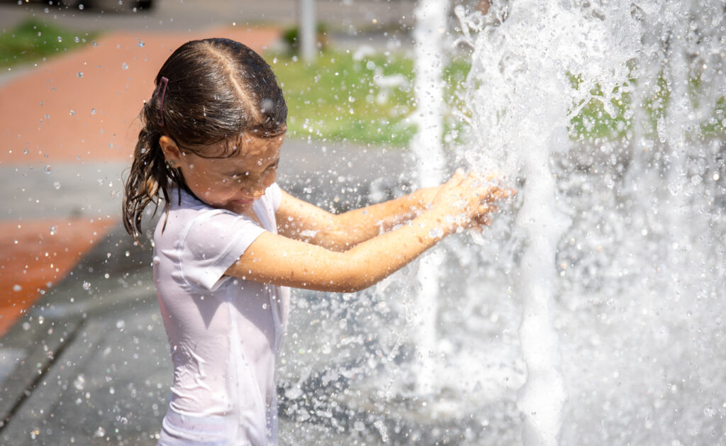 happy-little-girl-splashing-water-city-fountain-has-fun-escapes-from-heat (1)